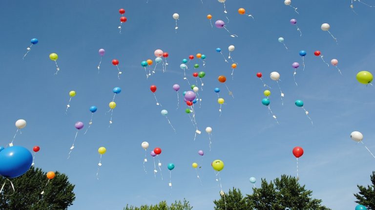 When helium gas balloons are released into the air how far into the sky do they reach